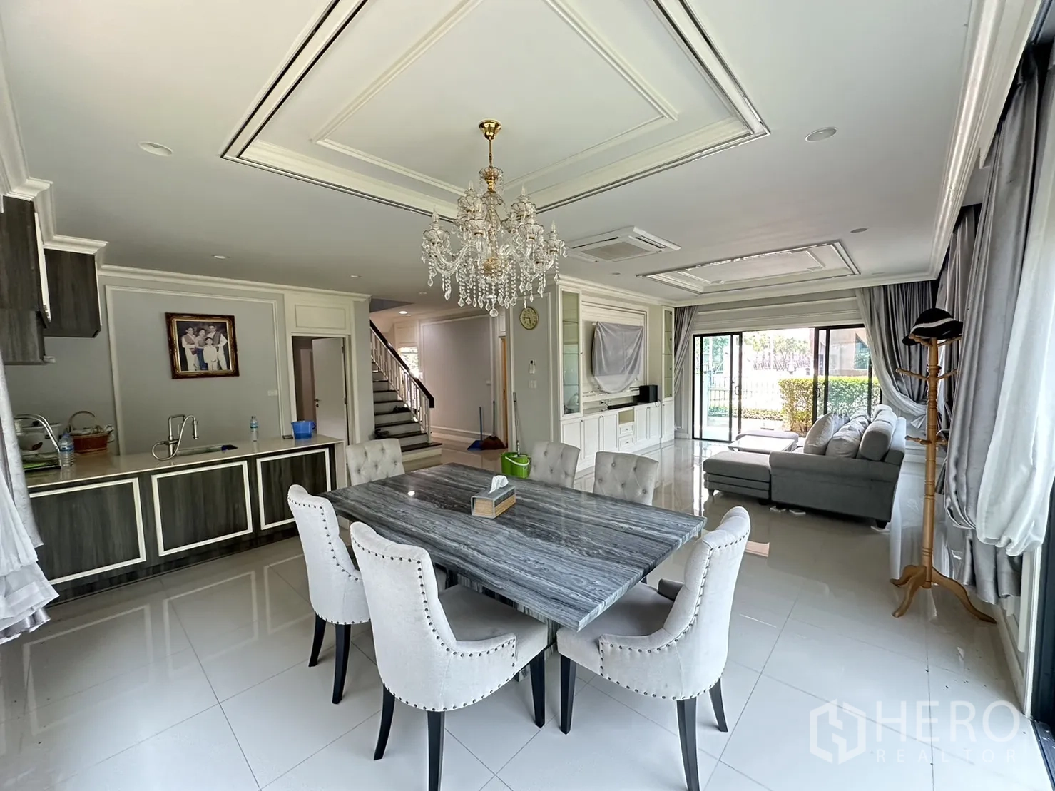 Detached House for rent or sale in Lam Luk Ka, Pathum Thani - Dining area beside pantry and staircase with large windows.