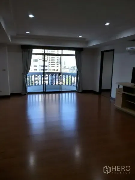 公寓 出租在Watthana, Bangkok - 客厅连接阳台，城市景观与经典栏杆设计。
