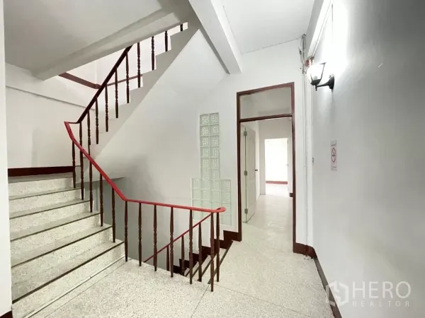 Home Office for rent in Din Daeng, Bangkok - Internal staircase with red handrail and glass-block feature connecting upper floors.