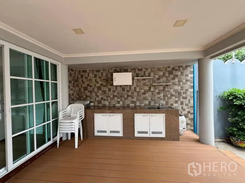 Detached House for rent in Bang Phli, Samut Prakan - Poolside outdoor pantry with sink and tiled wall under a roofed terrace.