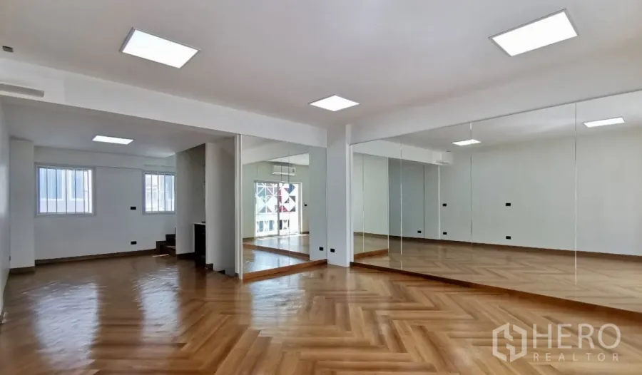 Home Office for rent in Watthana, Bangkok - Spacious home office studio with mirrored wall, herringbone wood floors and LED ceiling lights.