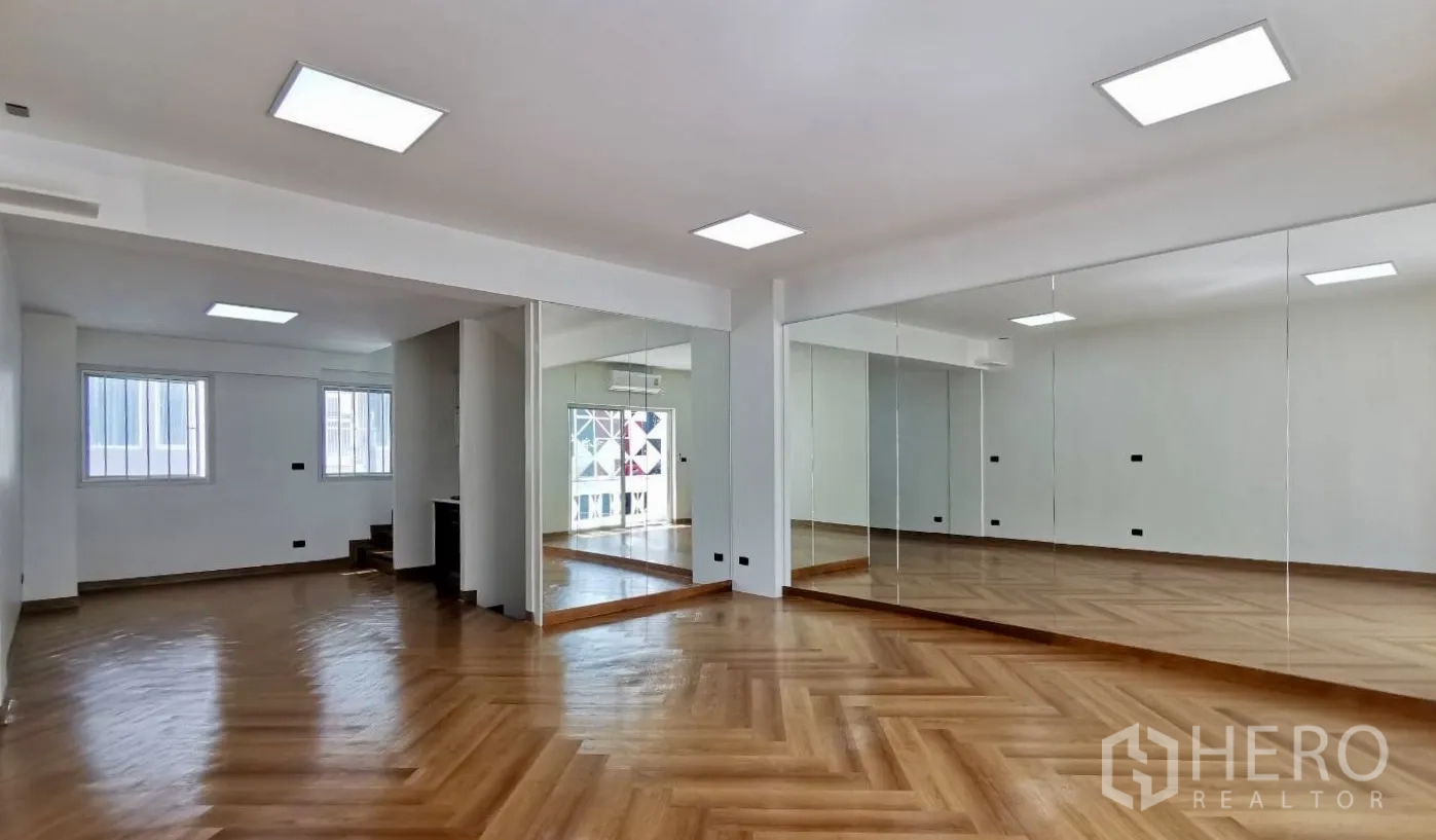 Home Office for rent in Watthana, Bangkok - Spacious home office studio with mirrored wall, herringbone wood floors and LED ceiling lights.