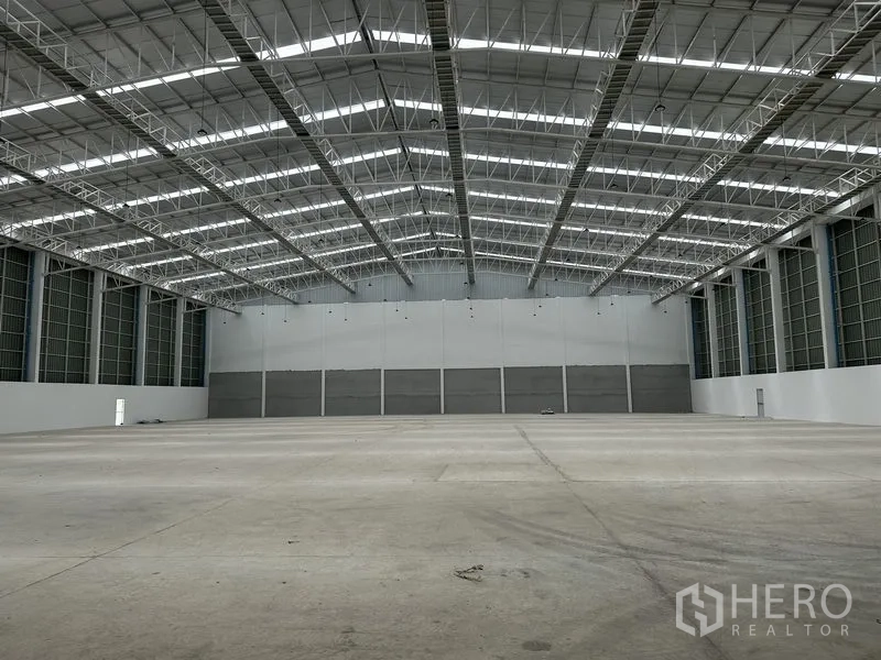 Factory for rent in Pathum Thani - Empty warehouse interior showing tall insulated walls and wide clear span.