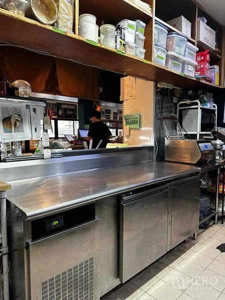 Retail Space for rent in Watthana, Bangkok - Stainless prep counter with undercounter chiller and overhead storage shelves.