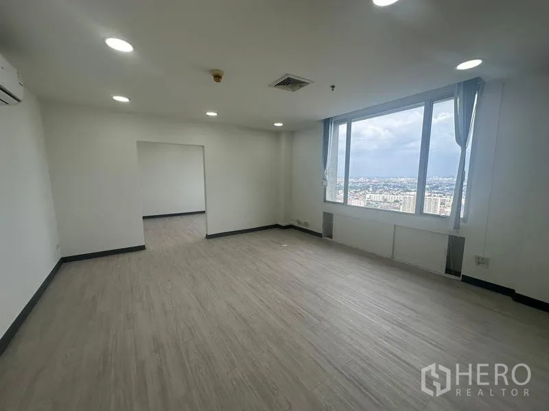 Office Space for rent - Meeting room with a large picture window and sweeping views of the Bangkok skyline.
