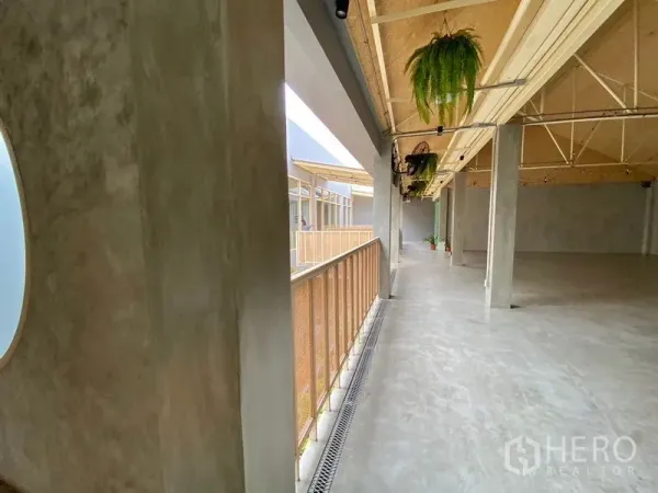 Retail Space for rent in Watthana, Bangkok - Spacious upper-level hall with polished concrete floors and exposed truss ceiling.