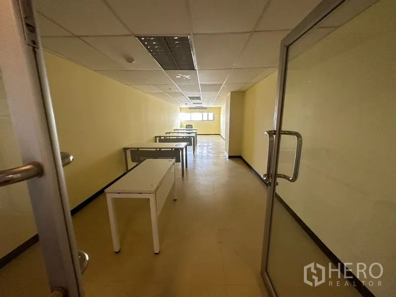 Office Space for rent in Watthana, Bangkok - Open-plan 51 sqm office with glass door, desks, suspended ceiling and window light in Watthana, Bangkok.