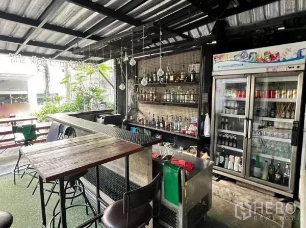 Retail Space for rent in Watthana, Bangkok - Close view of the bar with bottle shelves and a glass-door refrigerator in a fitted retail space.