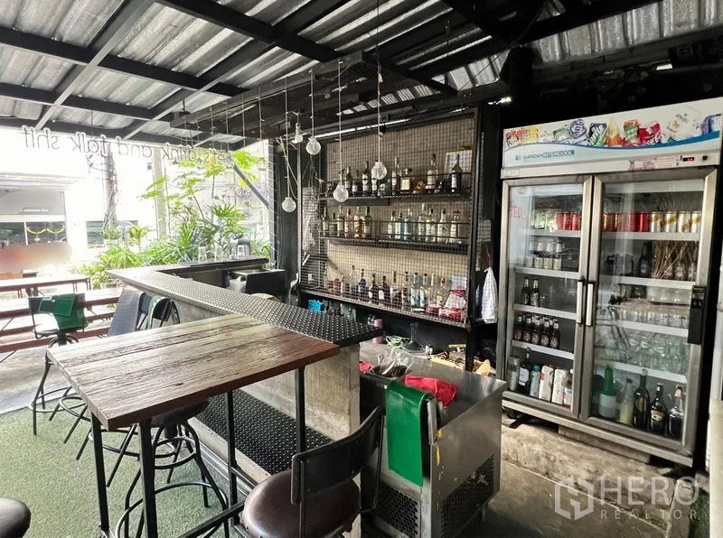 Retail Space for rent in Watthana, Bangkok - Close view of the bar with bottle shelves and a glass-door refrigerator in a fitted retail space.