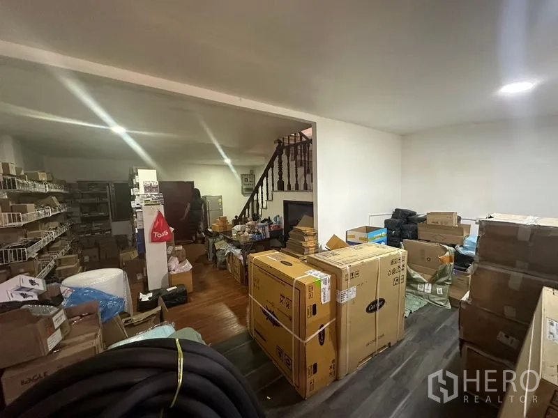 带办公室的家 出租在Sathon, Bangkok - 一层仓储打包间，配货架与楼梯，适合存放物料。