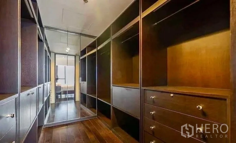 Condominium for rent - Walk-in closet with dark wood shelving and drawers.