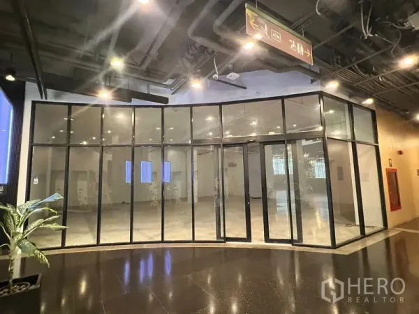 Retail Space for rent in Watthana, Bangkok - Corner retail space with full-height glass panels and central double doors facing the mall walkway.