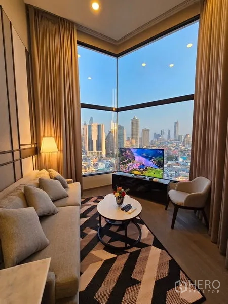 Condominium for rent - Cozy lounge with panoramic corner window, skyline view, and layered curtains.