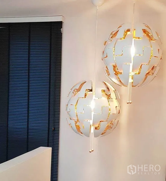 Detached House for rent in Bang Phli, Samut Prakan - Contemporary spherical pendant lights hanging by the stairwell with dark blinds behind.