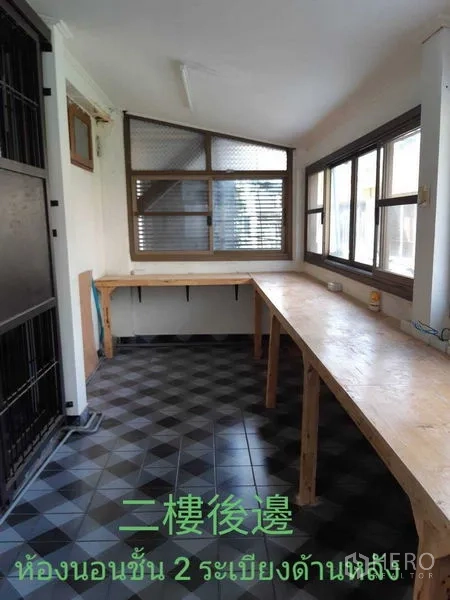 Townhouse for rent in Watthana, Bangkok - Enclosed balcony with long built‑in workbenches and tiled floor.