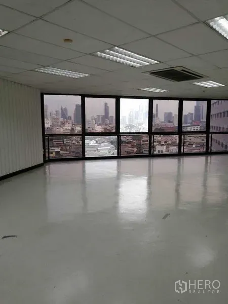 Office Space for rent in Bang Rak, Bangkok - Bright corner workspace with panoramic windows and urban cityscape.