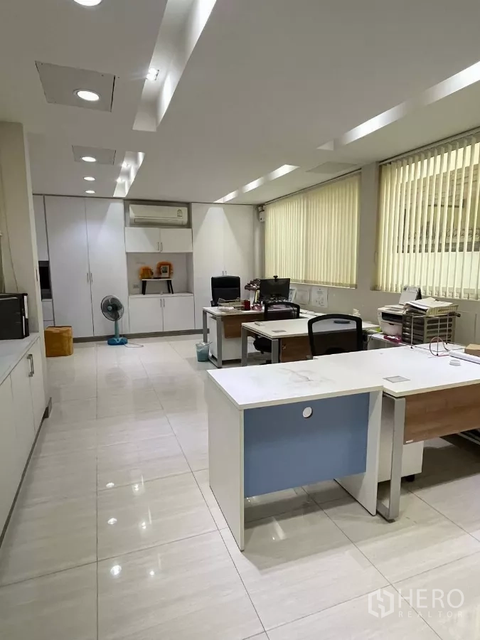 Home Office for rent in Khlong Toei, Bangkok - Spacious office workspace with multiple desks, storage cabinets and window blinds.
