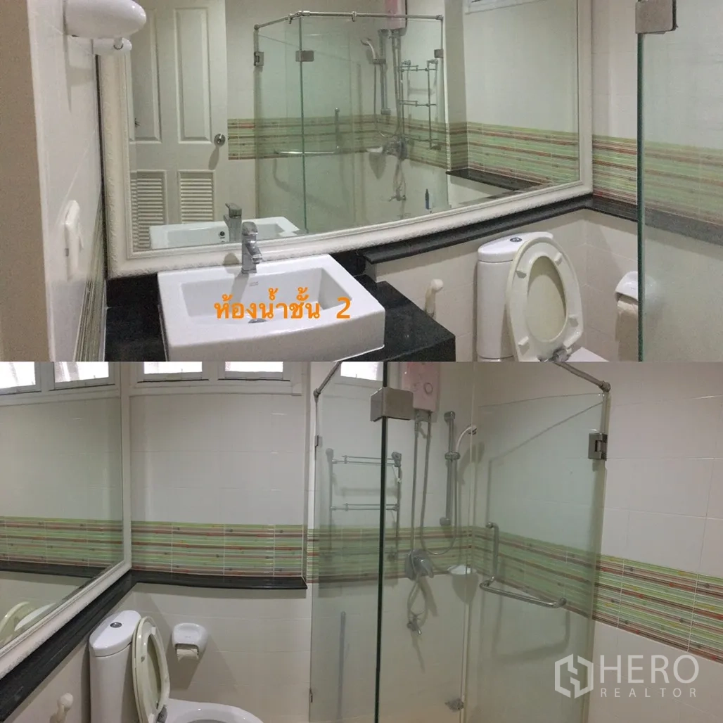 Detached House for sale in Lat Krabang, Bangkok - Second-floor bathroom with glass-enclosed shower, large mirror, vanity and toilet.