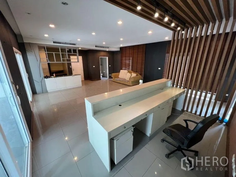 Home Office for rent or sale in Bang Phli, Samut Prakan - Open-plan office area with reception workstation and wood slat divider.