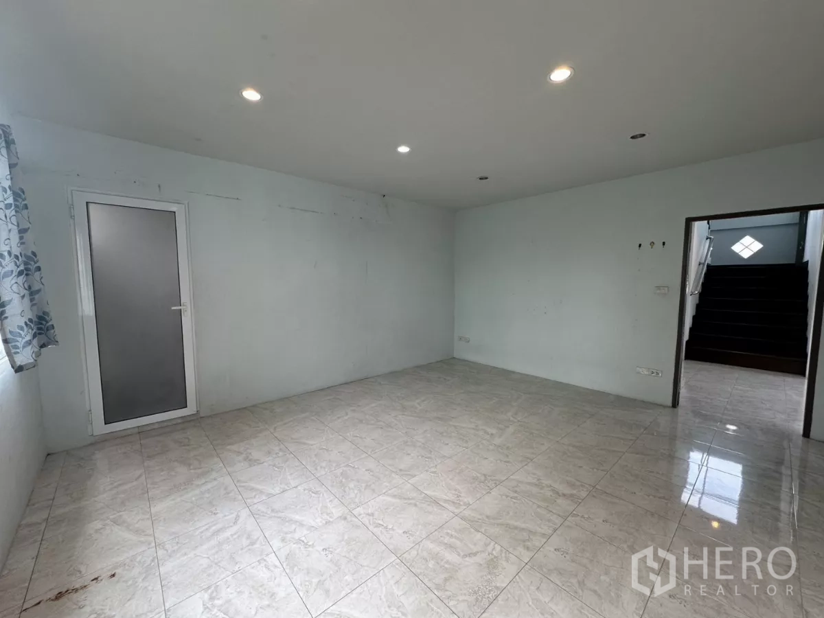 Home Office for rent - Bedroom with frosted door and stairs visible through the doorway.