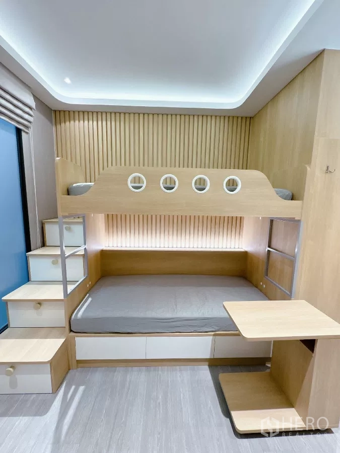 Townhouse for rent or sale in Lat Phrao, Bangkok - Custom bunk bedroom with stairs, desk and storage drawers.