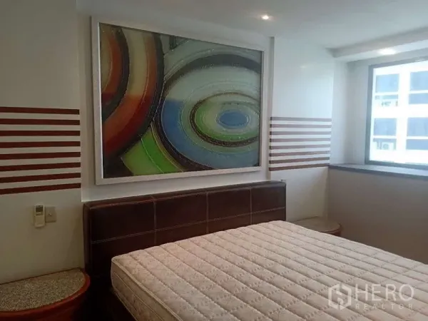 Condominium for rent in Khlong Toei, Bangkok - Bedroom with large abstract artwork above the headboard and natural light at President Park condo.