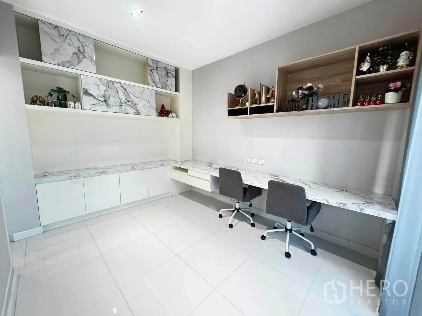 Detached House for rent in Saphan Sung, Bangkok - Home office with long marble-top desk, shelving, and two task chairs.