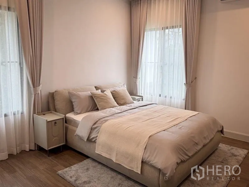Detached House for rent or sale - Serene bedroom in neutral tones with large windows and soft drapes.