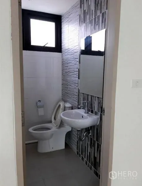 Office Space for rent in Bang Kho Laem, Bangkok - Clean tiled office bathroom with a sink, mirror and window.