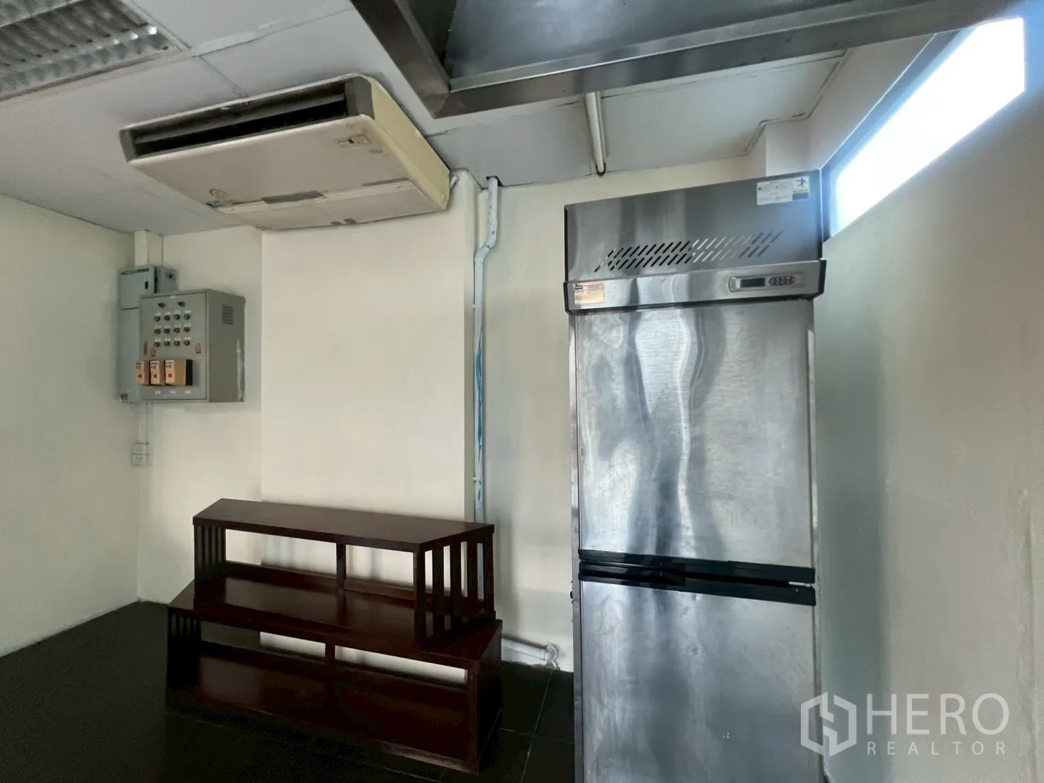 Retail Space for rent - Back-of-house pantry with stainless refrigerator, AC unit and electrical panel.
