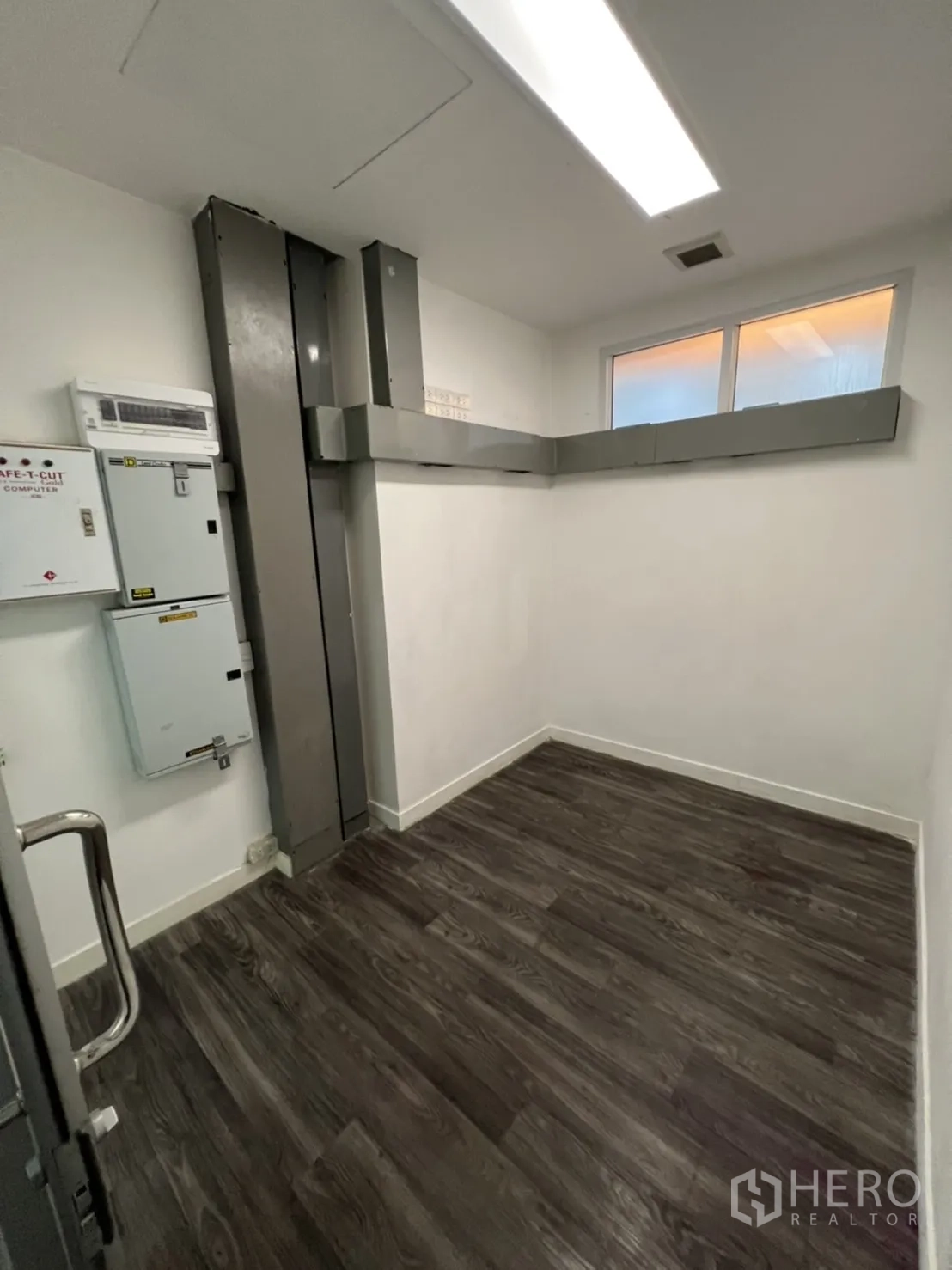 Retail Space for rent in Sathon, Bangkok - Compact equipment room with ducts, panels and window.