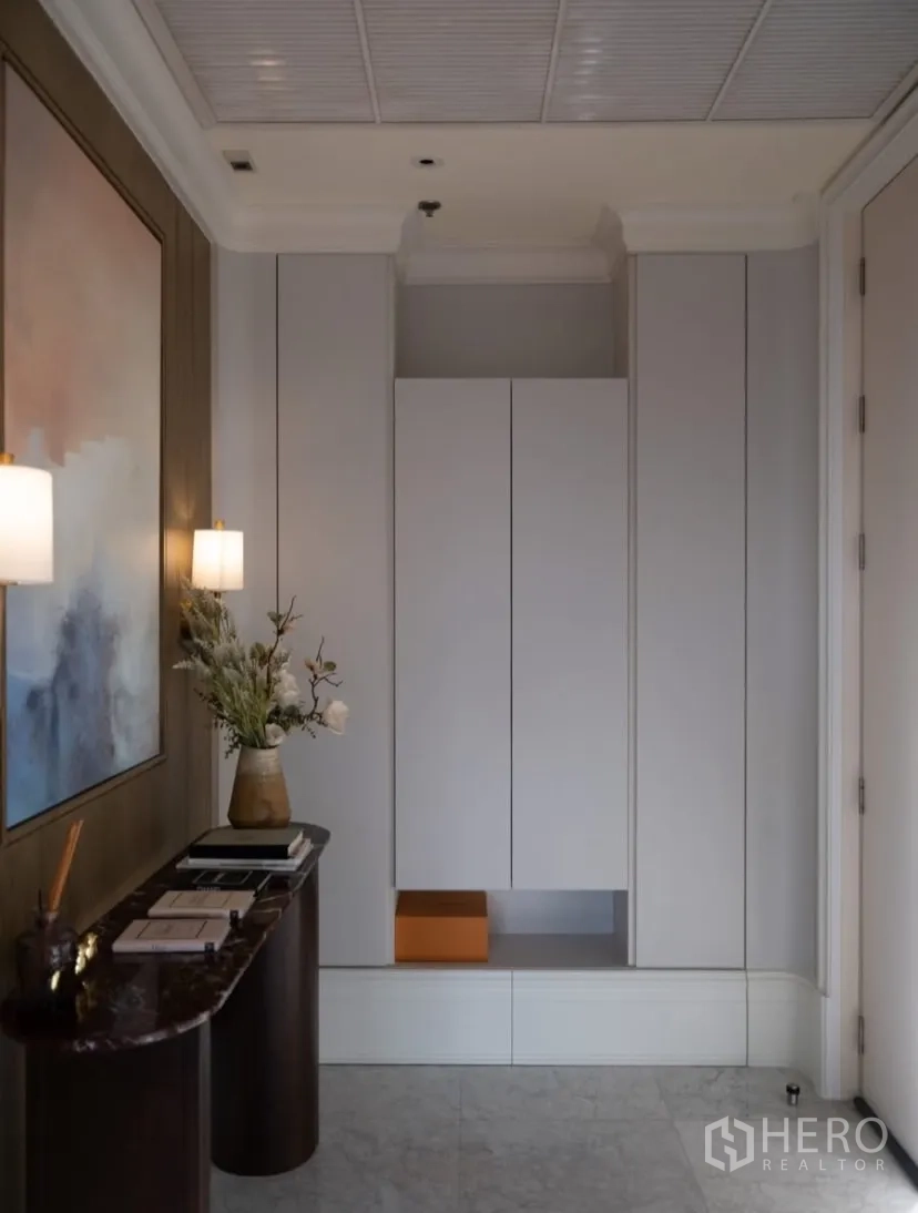 Condominium for rent or sale in Watthana, Bangkok - Foyer with console table, artwork and modern storage cabinet.