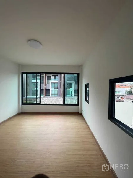 สำนักงานที่บ้าน ขาย - ห้องทำงานโล่งพร้อมผนังกระจกยาวและพื้นลายไม้โทนอุ่น