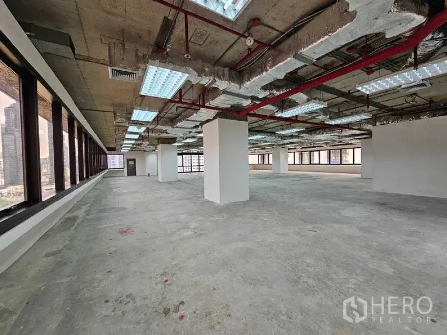 Office Space for rent in Bang Rak, Bangkok - Open office space with perimeter windows, exposed services and unfinished flooring.