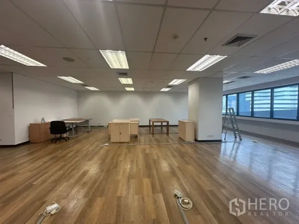 Office Space for rent in Bang Rak, Bangkok - Bright 135 sqm office showing floor power/data boxes, built-in AC vents and clean white walls.