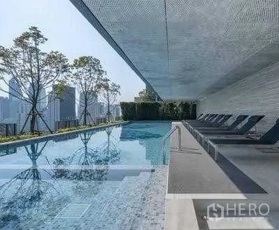 Condominium for rent - Infinity-edge pool with sun loungers and cityscape backdrop.