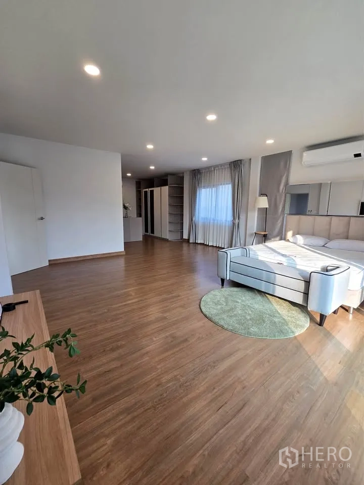 Detached House for rent or sale in Bang Phli, Samut Prakan - Oversized master bedroom with seating area, wardrobes, and big windows.
