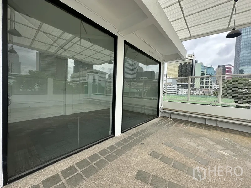 Retail Space for rent in Bang Rak, Bangkok - Glass storefront panels opening to a spacious terrace with urban views.