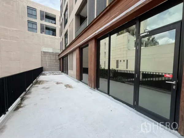 Retail Space for rent in Watthana, Bangkok - Long terrace walkway beside the retail façade with black railing.
