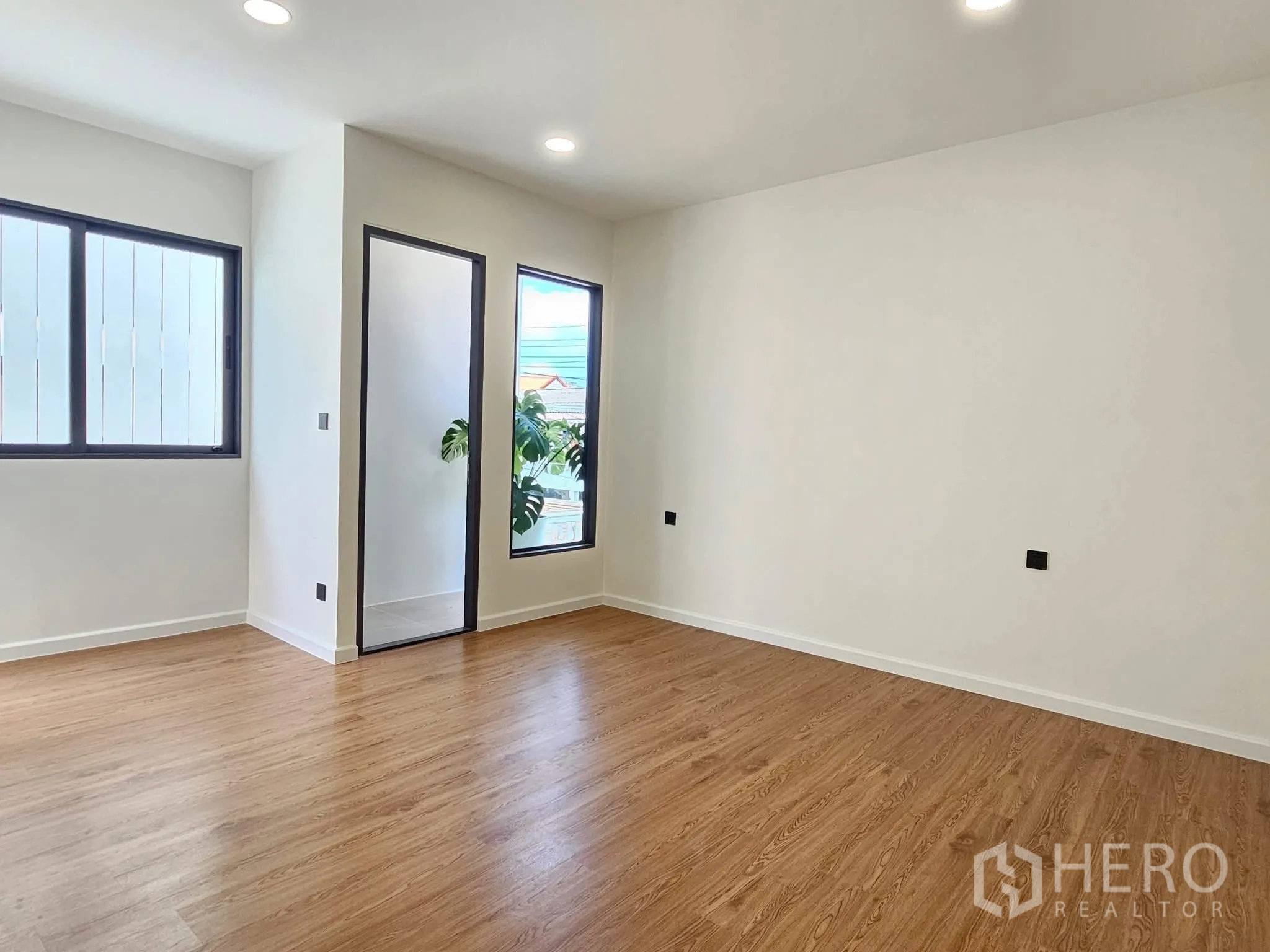 独栋房屋 for sale in Lat Phrao, Bangkok - 宽敞卧室，大窗与通向小阳台的玻璃门。