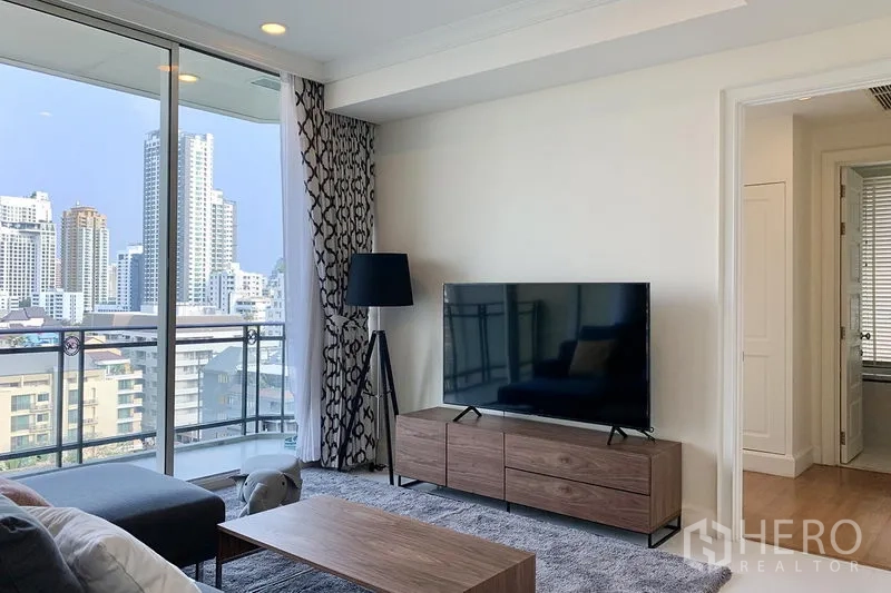 公寓 出租在Watthana, Bangkok - 客厅配电视柜与落地灯，可通往观景阳台。