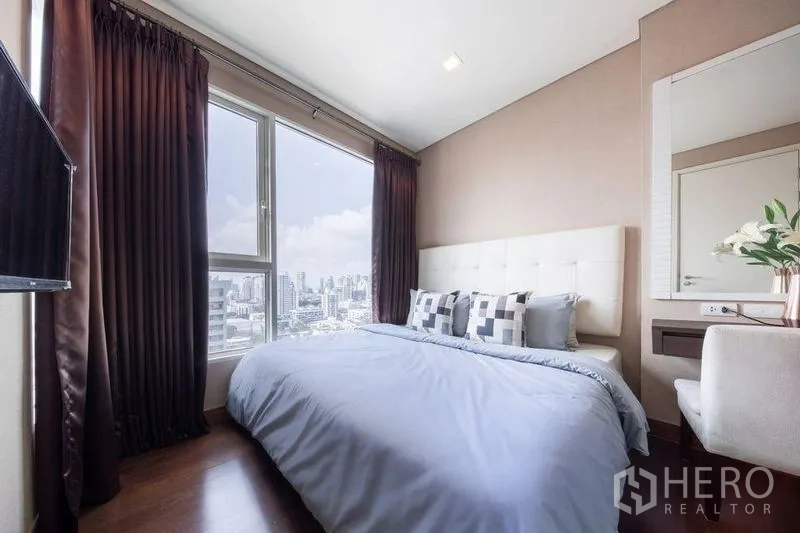 Condominium for rent or sale in Watthana, Bangkok - Sunlit bedroom with floor-to-ceiling window and panoramic Bangkok city view.
