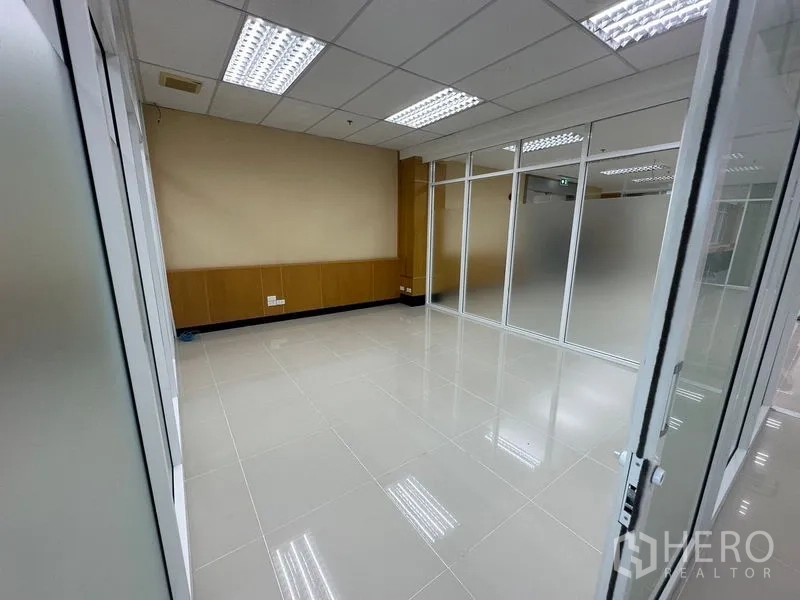 Office Space for rent in Suan Luang, Bangkok - Private office room with frosted glass partitions, polished tiles, and fluorescent ceiling lights.