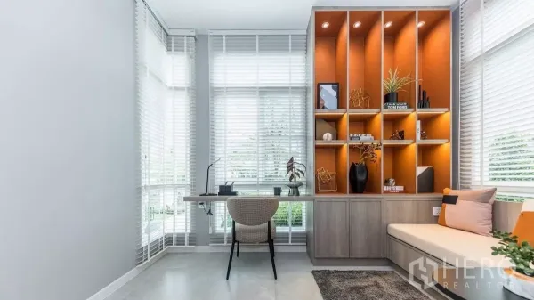 Detached House for rent in Prawet, Bangkok - Bright home office with floor-to-ceiling windows, built-in desk and illuminated shelving.