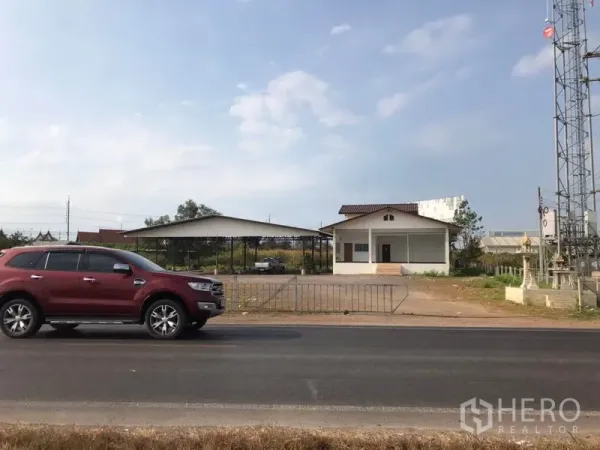 Land for sale in Mueang Samut Sakhon, Samut Sakhon - Property frontage on main road with gated entrance, small office and a nearby telecom tower.