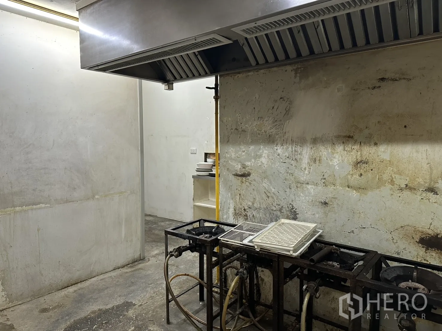Retail Space for rent in Watthana, Bangkok - Back-of-house kitchen with commercial exhaust hood and gas burner frames.