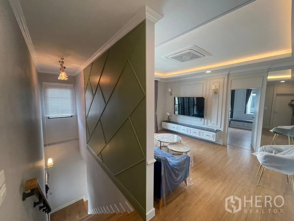 Detached House for rent in Bang Phli, Samut Prakan - Staircase with geometric accent wall and an upper lounge with TV unit.