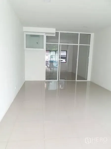 Home Office for rent in Bang Rak, Bangkok - Ground-floor open space with glossy tile floors and a full-height glass partition.