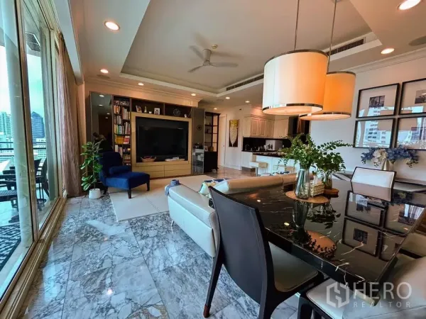 Condominium for sale in Watthana, Bangkok - Open-plan lounge and dining area with marble flooring, built-in TV wall and sliding doors to the balcony.