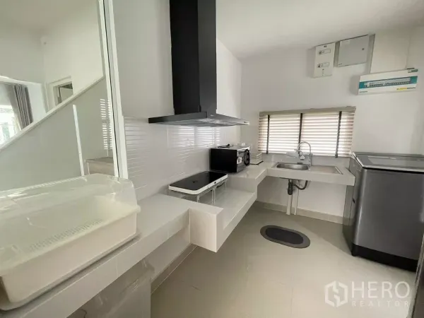 บ้าน ให้เช่าหรือขายในBang Phli, Samut Prakan - ครัวปิดขนาดกะทัดรัด มีเตา เครื่องดูดควัน อ่างล้างจาน และเครื่องใช้ไฟฟ้าข้างหน้าต่าง